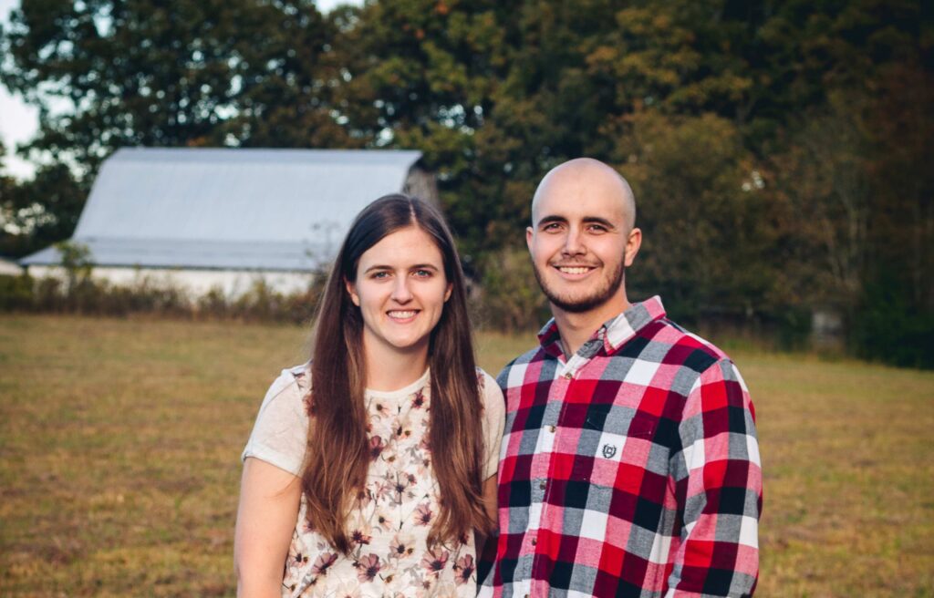 Woman and man standing in field