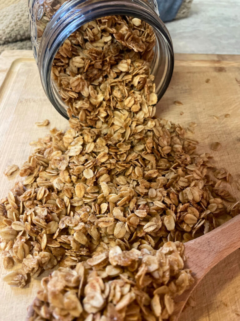 granola pouring out of a glass jar