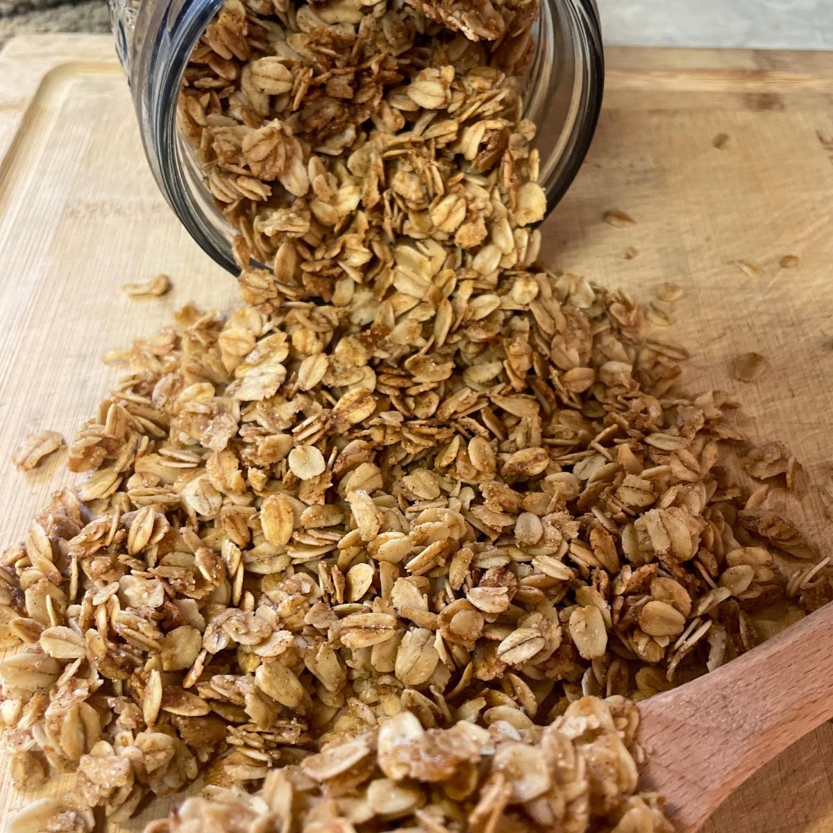 granola pouring out of a glass jar