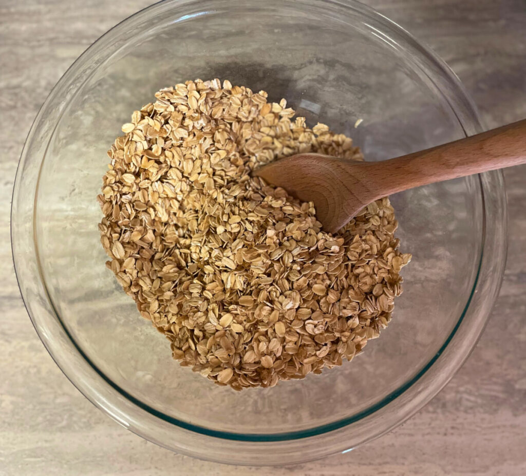 oats and ingredients in a bowl with wooden spoon