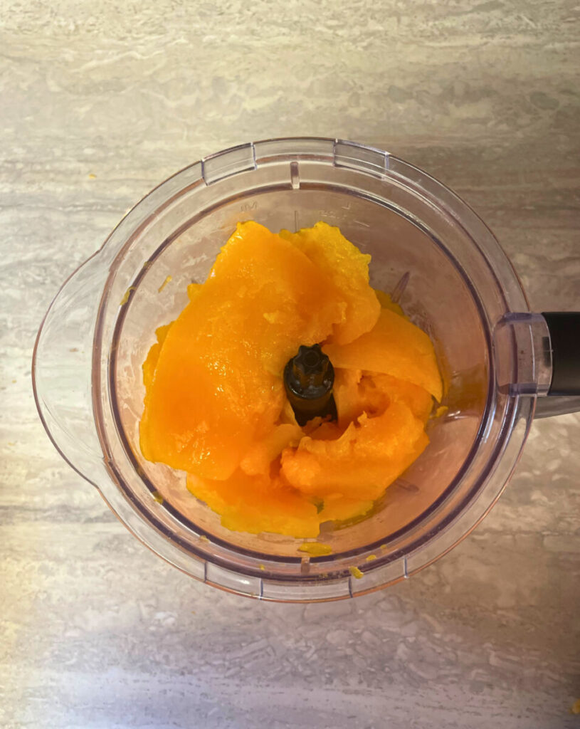 chunks of cooked pumpkin in a food processor