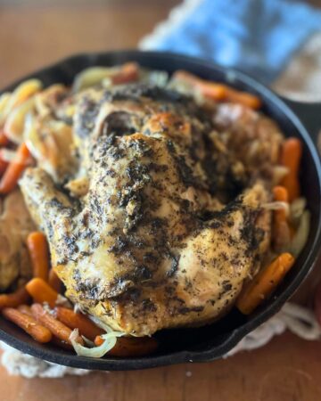 cooked whole chicken in a cast iron skillet