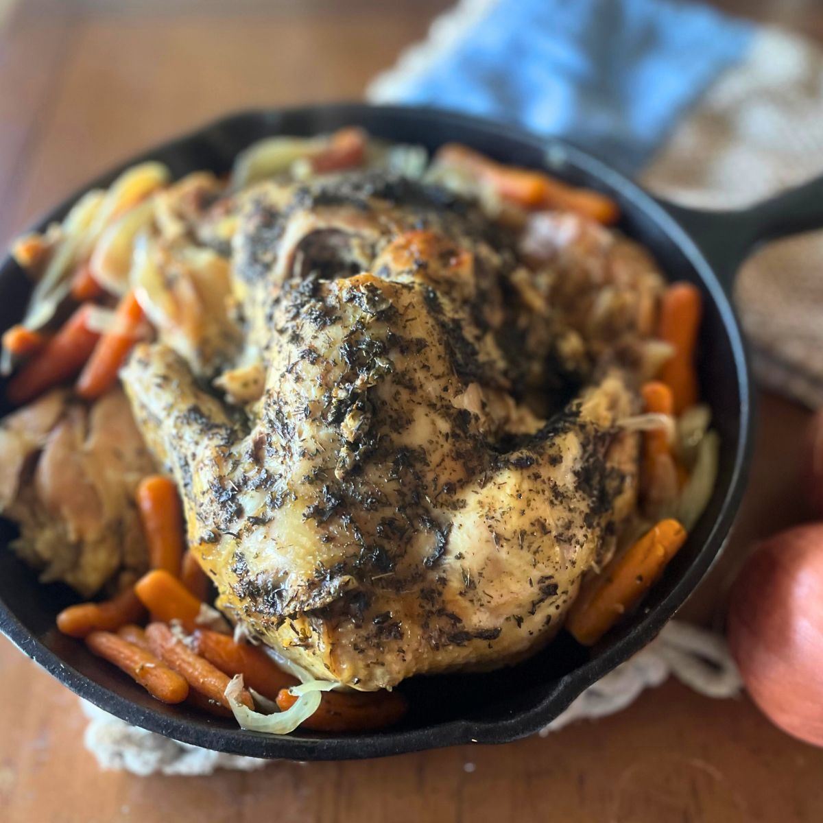 cooked whole chicken in a cast iron skillet