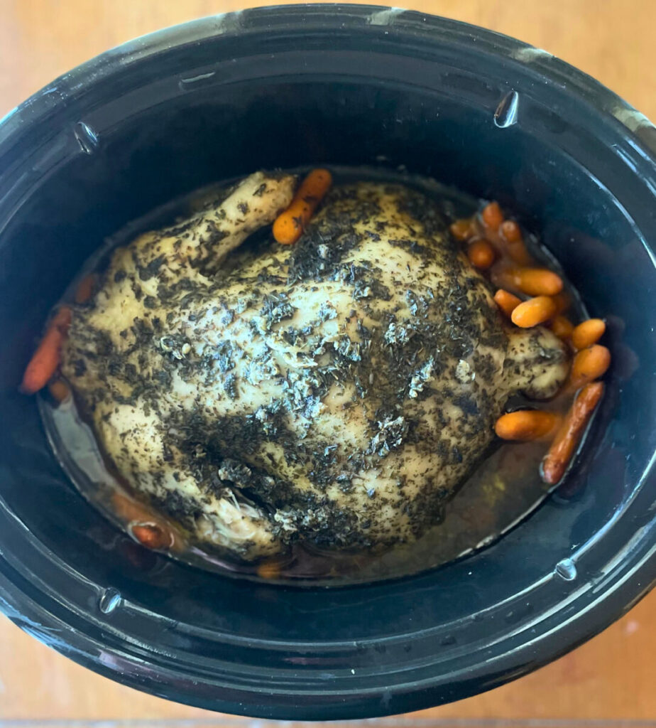 whole cooked chicken in crockpot with carrots