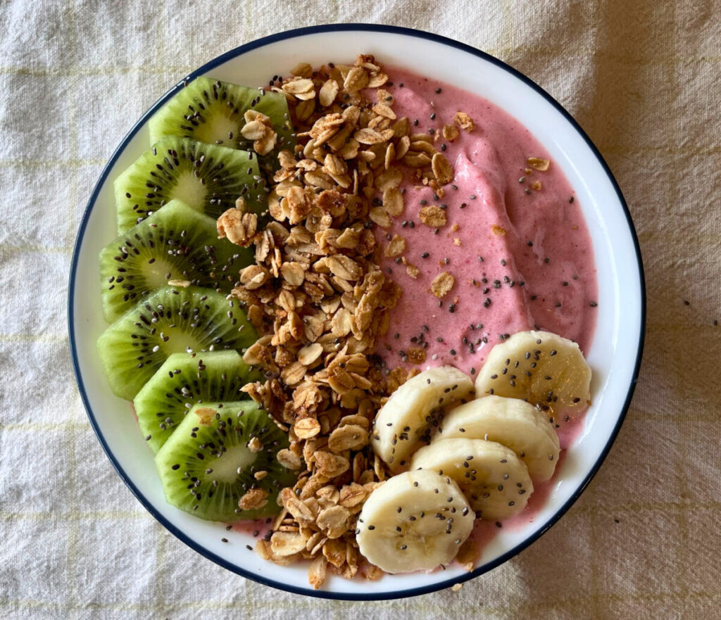smoothie bowl with fresh fruit and granola toppings