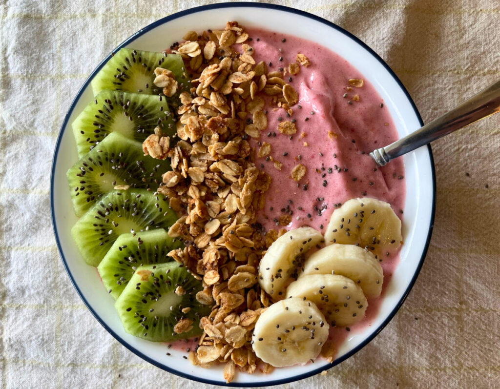 pink smoothie bowl with toppings