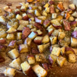 cut and roasted potatoes on baking stone