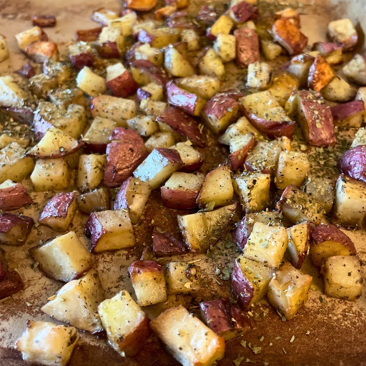 cut and roasted potatoes on baking stone